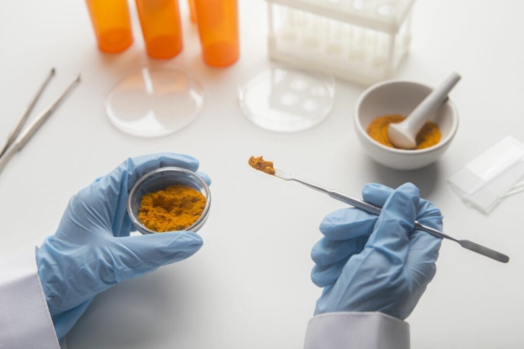Laboratory professional's hands with spoon and a small container